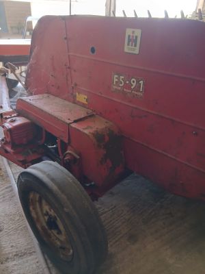 a red tractor that is parked in a garage