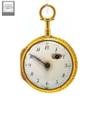 a gold pocket watch with a chain hanging from it ' s side