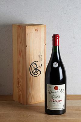 a bottle of wine sitting next to a wooden box