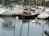 many boats that are docked in the water together