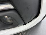 a close up of the front bumper of a white car