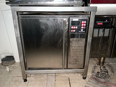 a stainless steel oven sitting on the floor in a kitchen