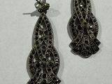 pair of black and white diamond earrings on a white surface