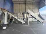 a picture of a factory with a conveyor belt and a conveyor belt