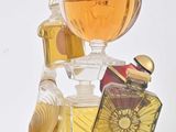 a bottle of perfume with a bird on top of it