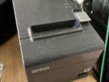a small printer sitting on a table next to a bag