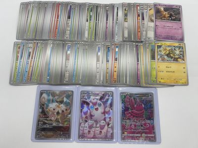 a lot of different pokemon cards on the table