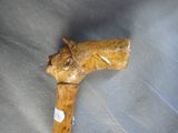 a wooden walking stick with a horse head on it