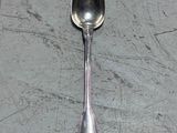 a silver spoon with a spoon handle on a table