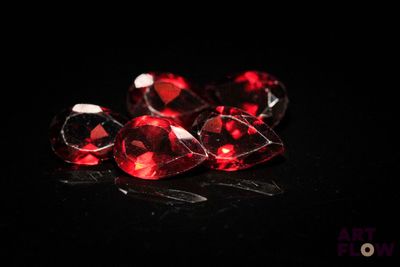 three red diamonds on a black surface