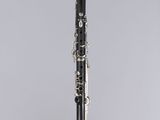 a black and silver clarinet on a clear surface