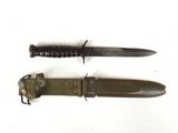 pair of military knifes on a white background with a black handle