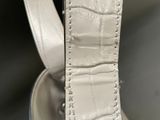 a close up of a white bag with a strap on it