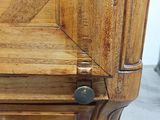 a close up of a wooden cabinet with a metal knob on it