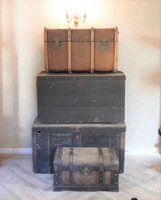 three trunks stacked on top of each other in a room