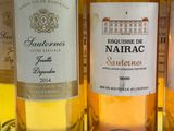 several bottles of wine are lined up on a table