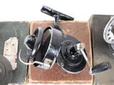 a black fishing reel sitting on top of a box