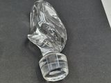 a close up of a glass bottle on a black surface