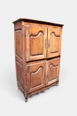 an old wooden cabinet with two doors and a drawer underneath it