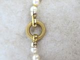 pearl necklace with a gold clasp and a white pearl bead