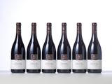 six bottles of red wine lined up in a row