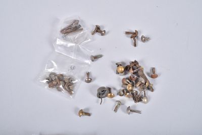 many different types of screws and nuts on the table