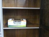 a wooden bookcase with a box on top of it
