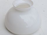 a white vase sitting on a table with a white background