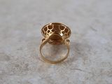an image of a gold ring with a stone in the middle