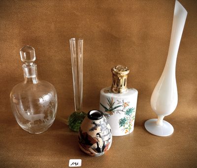 three glass vases and a glass bottle on a table