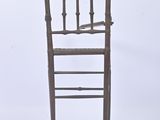 a wooden chair that is sitting on a white surface