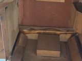 a wooden chair that has a wooden seat on top of it