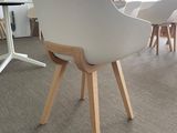 a white chair with wooden legs and a white chair with a white seat