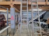 many ladders that are sitting in the middle of a room