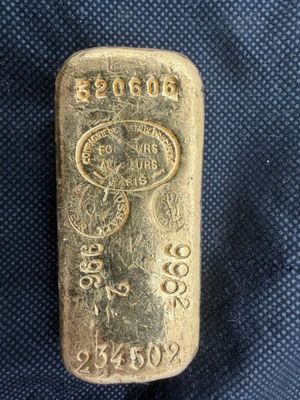 un lingot d'or posé sur un tissu bleu
