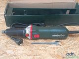 an image of a corded electric tool sitting on top of a box