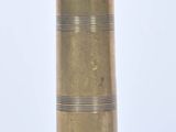 a gold vase that is sitting on a white surface