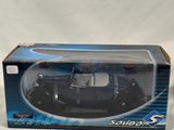 a box with a toy car inside of it on a white surface