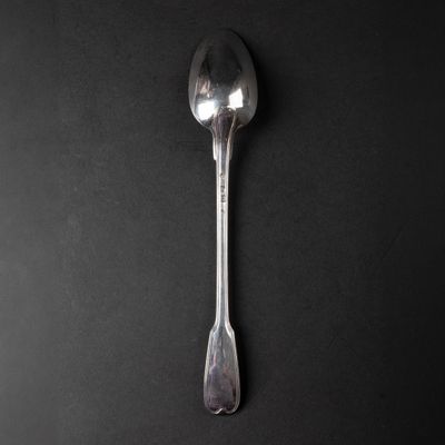 a spoon that is sitting on a black surface