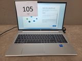 a laptop computer sitting on a table with a clock on the screen