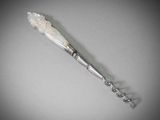 a silver spoon with a white flower on it