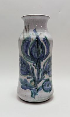 a blue and white vase sitting on a white surface