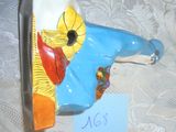 un vase bleu orné d'un visage de clown jaune et rouge
