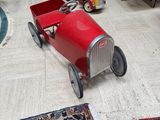 a toy car that is sitting on the floor in the living room