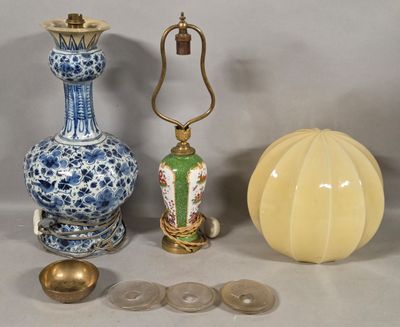 three vases and a lamp on a table