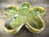 une jardinière verte en forme de fleur posée par terre
