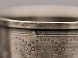 a close up of a metal cup on a table