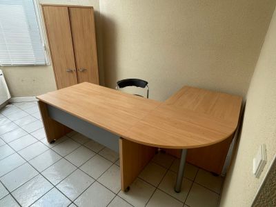a desk with a chair in the corner of the room