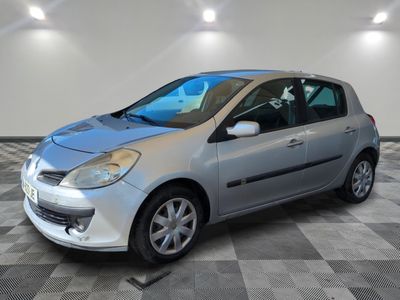 a picture of a small silver car parked in a garage