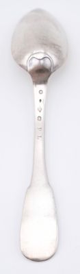 a spoon that is sitting on a white surface
